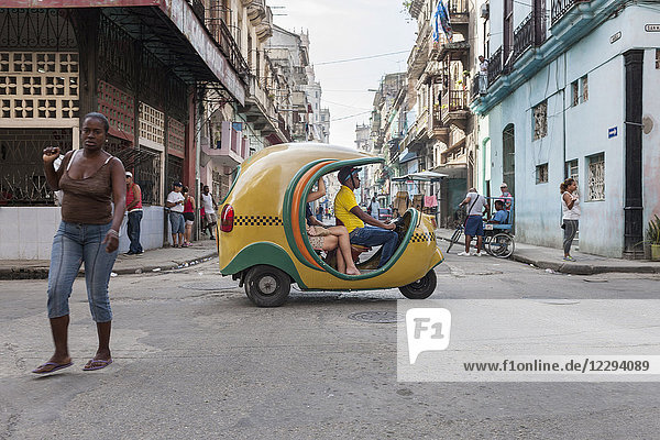 Coco taxi on in motion on city street  Havana  Cuba