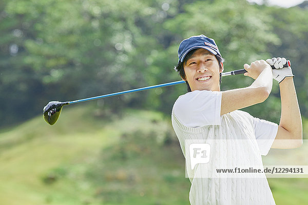 Japanese golf player on course
