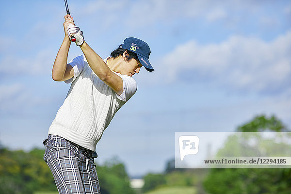Japanese golf player on course