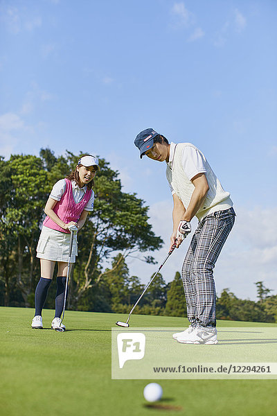 Japanese golf players on course