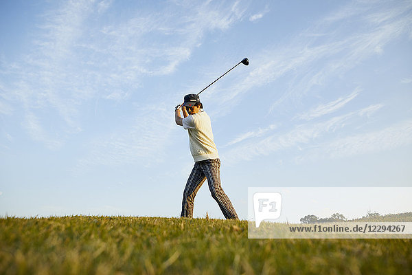 Japanese golf player on course