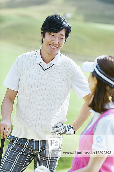 Japanese golf players on course