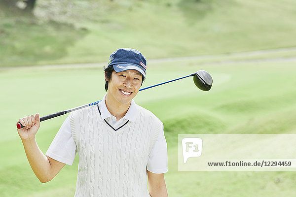 Japanese golf player on course