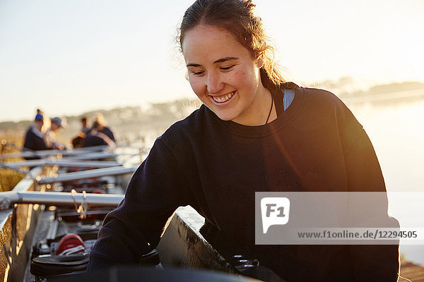 Smiling female rower preparing scull
