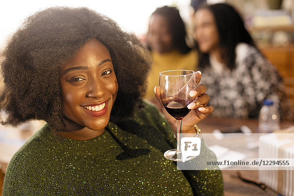 Portrait smiling  confident young woman drinking red wine
