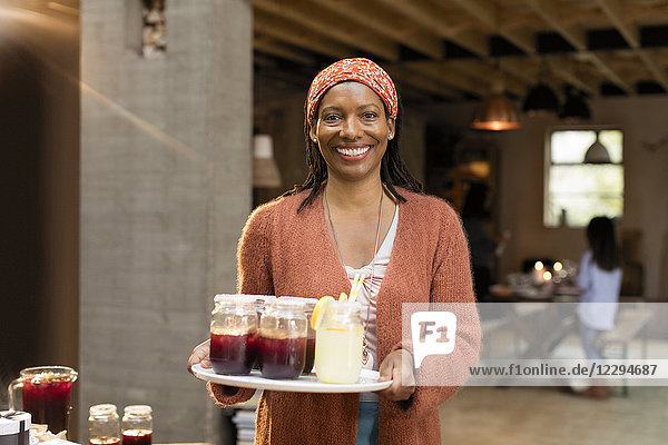 Portrait smiling  confident woman serving lemonade and sangria