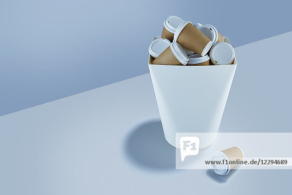 Recyclable coffee cups stacked in garbage can