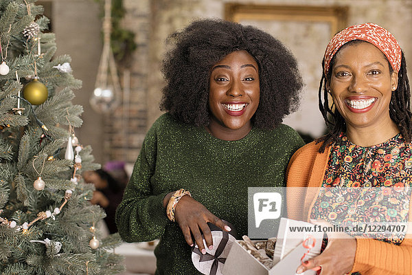 Portrait lächelnd  begeisterte Mutter und Tochter eröffnen Weihnachtsgeschenk