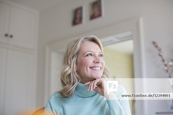 Smiling ambitious mature woman looking away
