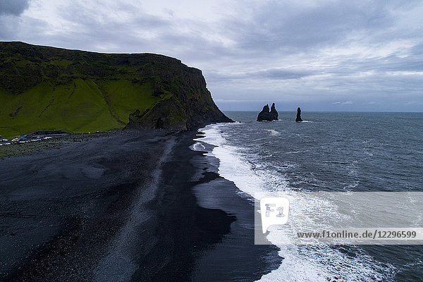 Scenic view of beach against cloudy sky  Iceland