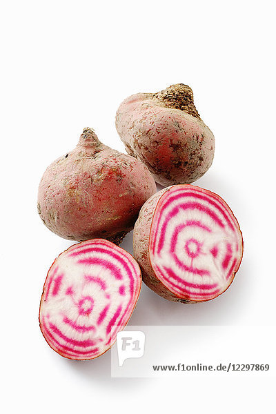 Chioggia beets  whole and halved against a white background