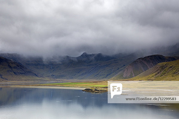 Clouds over remote landscape and water Iceland