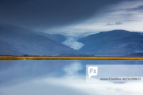 Glacier over tranquil placid ocean Vatnajokull Iceland