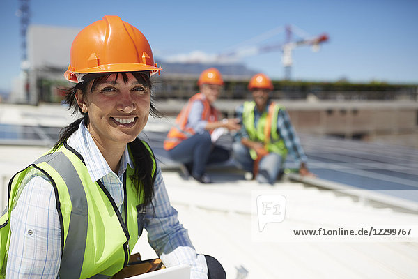 Portrait smiling  confident female engineer at sunny power plant