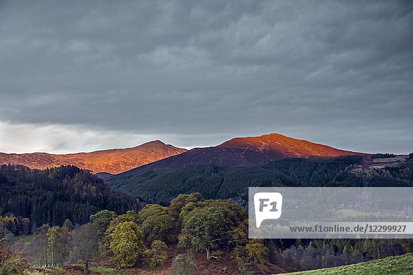 Sunlight illuminating tranquil mountaintops  Scotland