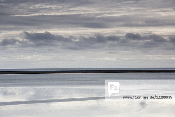 Tranquil blue and gray clouds and ocean Lagoon Hofn Iceland