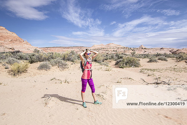 Full length shot of woman standing in desert scenery of Grand Staircase-Escalante National Monument  Utah  USA