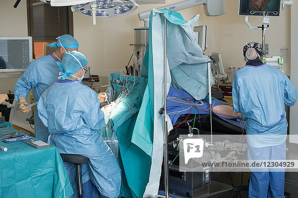 Reportage on the removal of a cerebral tumor (glioma) while awake at Nice Hospital  France. Awake surgery consists of waking the patient during the operation in order to precisely locate  using electrical stimulation  crucial areas for vital functions (language  motor function etc.)  with the aim of preserving them during the ablation of the tumor. End of the operation. The skull is closed.