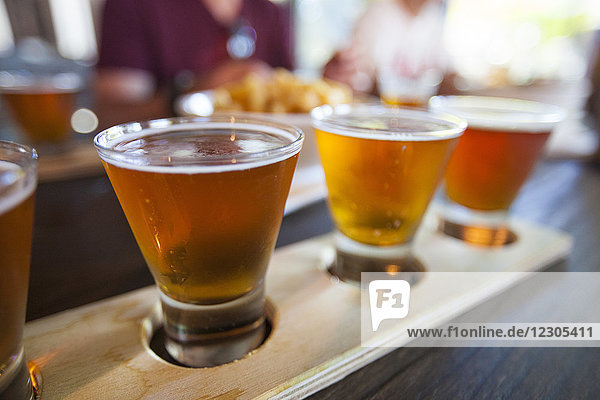 Close up photograph of flight of beer in glasses on table