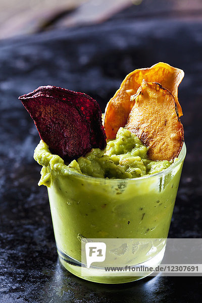 Glass of Guacamole and vegetable Chips
