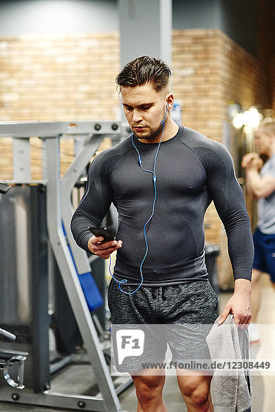 Man using cell phone at the gym