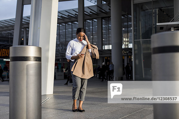 Businesswoman looking at smartphone