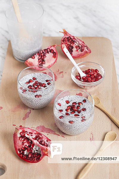Two glasses of chia pudding with pomegranate seed