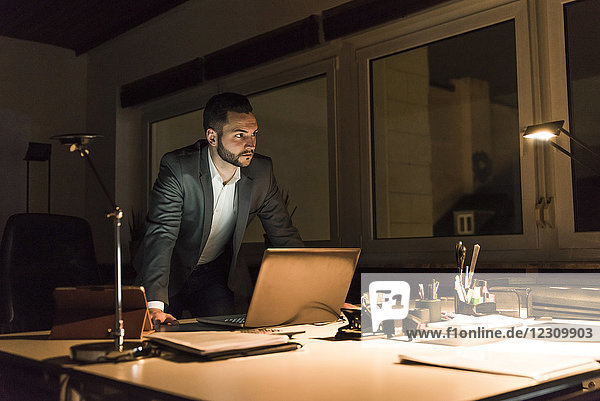 Businessman working in office at night