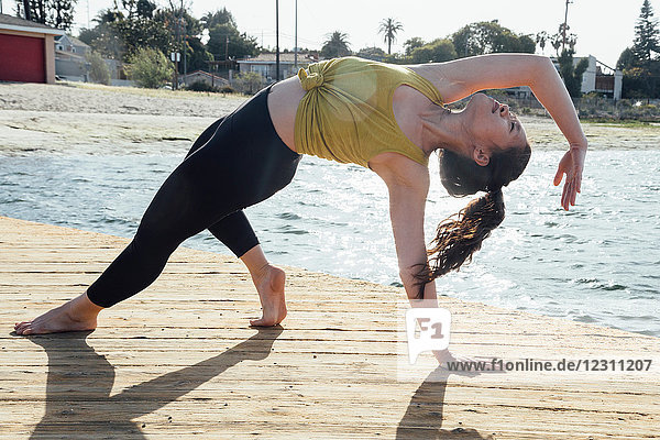 Young woman outdoors  in yoga position  Long Beach  California  USA