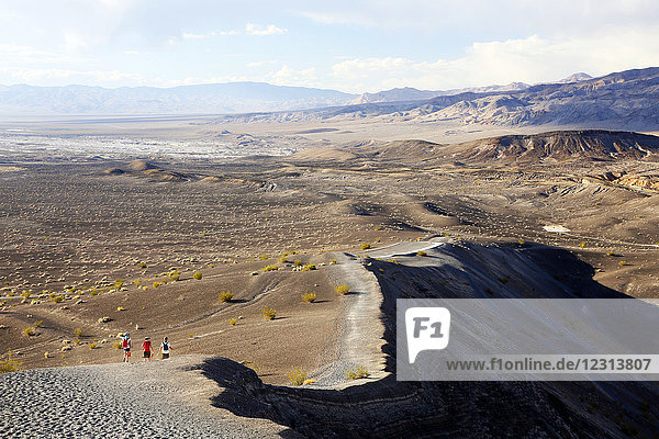 USA. California. Death Valley. Ubehebe Crater. Volcanic crater. Hikers on the volcano.