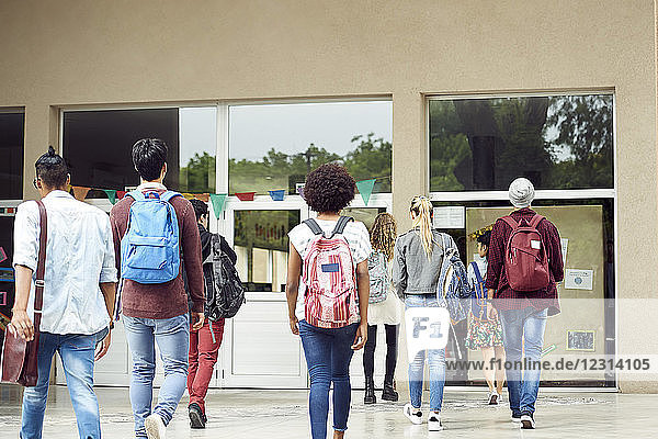 College students walking on campus  rear view