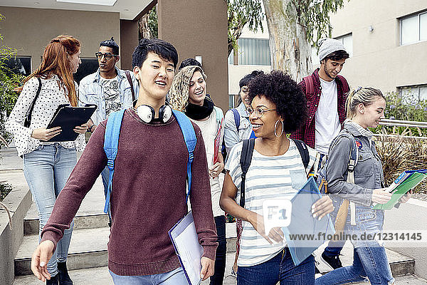 College students walking and chatting together on campus