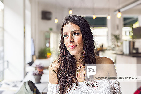 Portrait of young woman in cafe