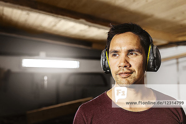 Portrait of man wearing ear muffs