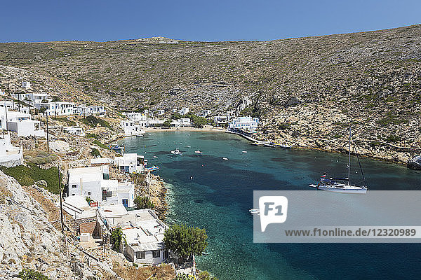 View over crystal clear water and fishing boats in harbour  Cheronissos  Sifnos  Cyclades  Aegean Sea  Greek Islands  Greece  Europe