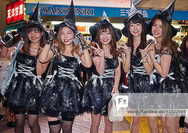 A group of young Japanese girls dressed as witches at the Halloween celebrations in Shibuya Tokyo Japan Asia