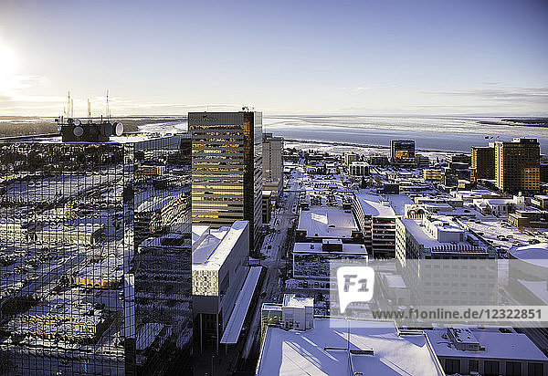 Luftaufnahme von Bürogebäuden mit Glasfassaden in der Innenstadt von Anchorage  Cook Inlet im Hintergrund  Schnee auf den Dächern der Stadt  Süd-Zentral-Alaska im Winter; Anchorage  Alaska  Vereinigte Staaten von Amerika