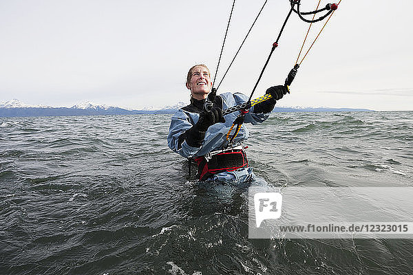 Woman in the water preparing to kitesurf  Kachemak Bay  South-central Alaska  USA