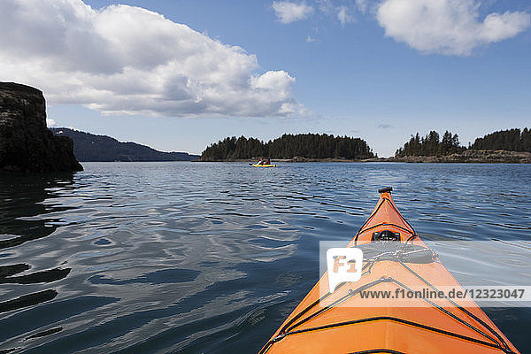 Point of view while sea kayaking in Kachemak Bay in the spring  South-central Alaska; Alaska  United States of America