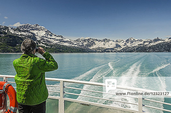 Tourist on the tour boat Baranof Wind photographing Glacier Bay National Park and Preserve  Southeast Alaska; Alaska  United States of America