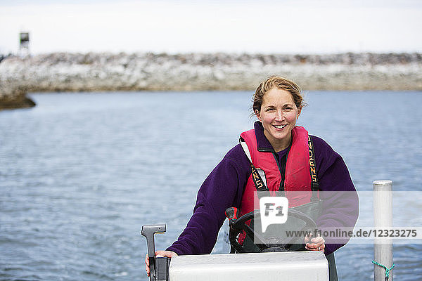 Woman set-netter drives a set-net skiff in Seldovia Bay  South-central Alaska; Alaska  United States of America