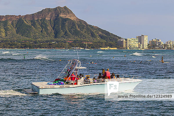 View of Diamond Head  Waikiki  a Hawaiian Parasail boat and surfing from Magic Island  Ala Moana Beach Park; Honolulu  Oahu  Hawaii  United States of America