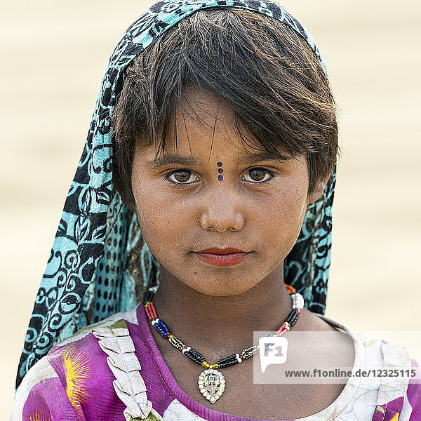 Portrait of a young Indian girl with markings on her face; Damodara  Rajasthan  India