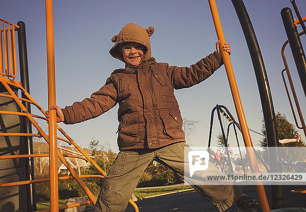 Portrait of a young boy playing on playground equipment; Langley  British Columbia  Canada