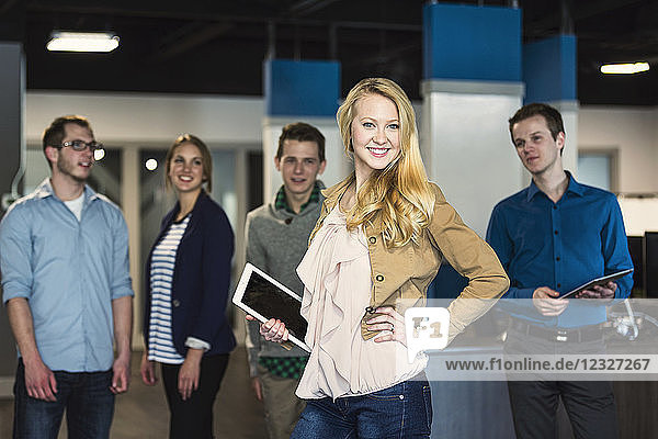 Portrait of a group of young millennial professionals standing together in the workplace; Sherwood Park Alberta  Canada