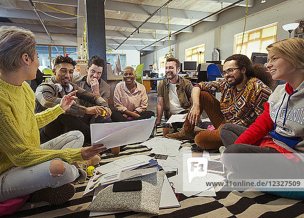 Creative business team meeting  brainstorming in circle on floor