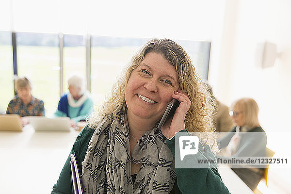 Smiling businesswoman talking on smart phone