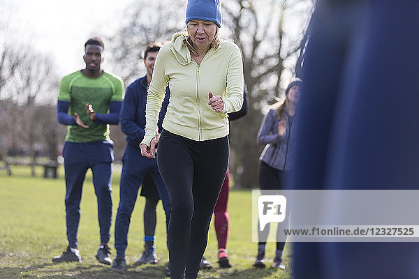 Determined senior woman exercising in park
