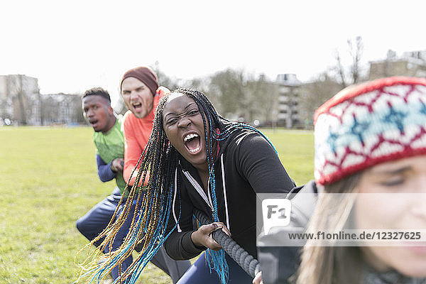 Determined team pulling rope in tug-of-war