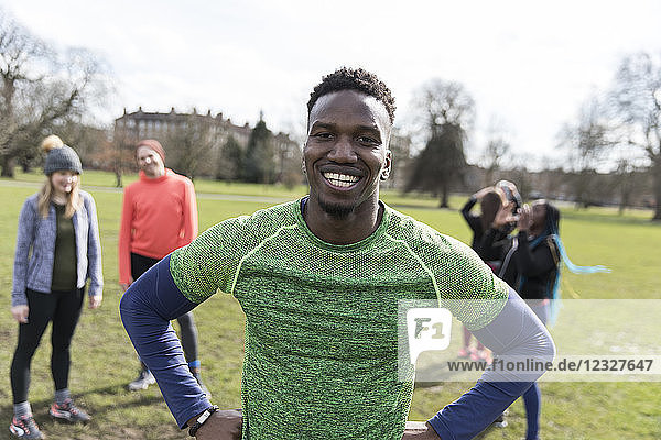 Portrait smiling  confident male runner in sunny park